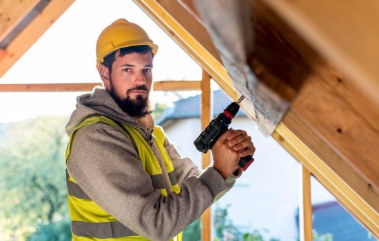 man-holding-hammer-drill-looking-away